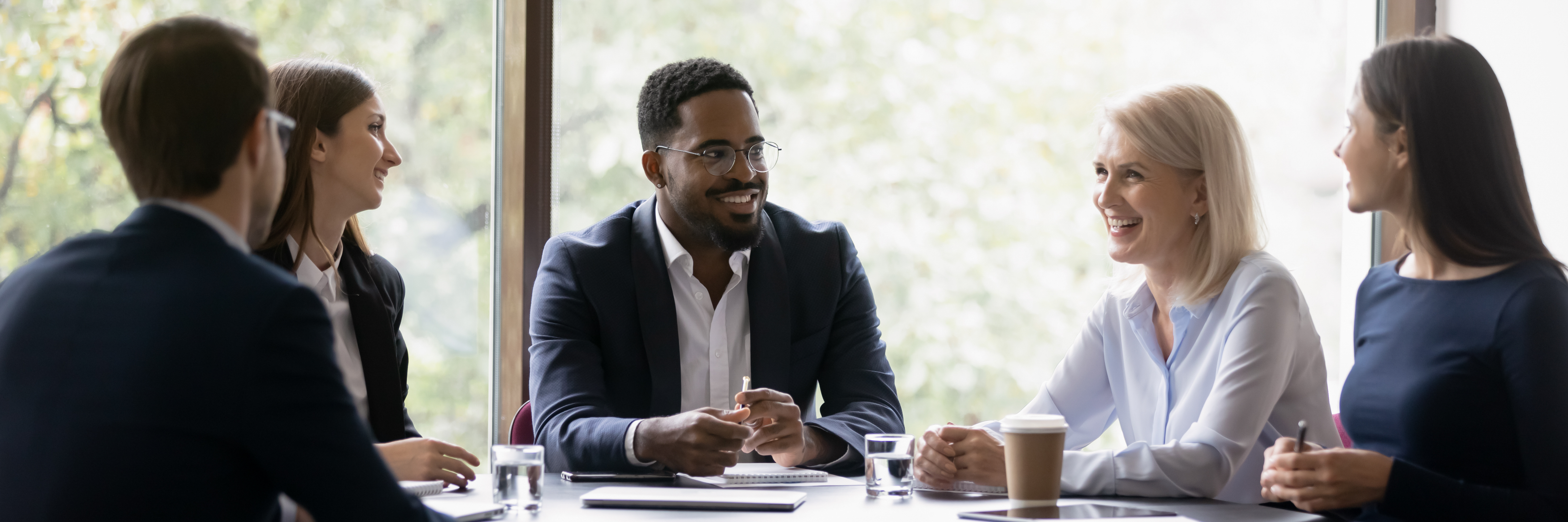 Leader and employees talking in office meeting room together